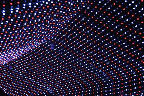 polka dot turned on white, blue, and red string lights at night rug